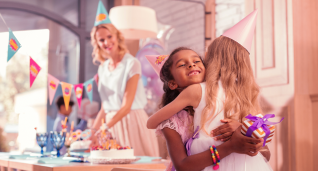 little girls hugging at princess birthday party